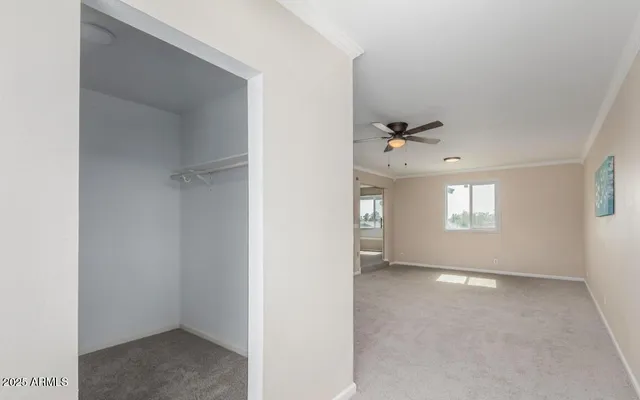 an empty room with windows and closet