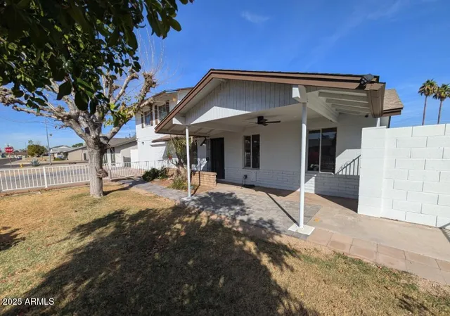 a view of a house with snow on the road