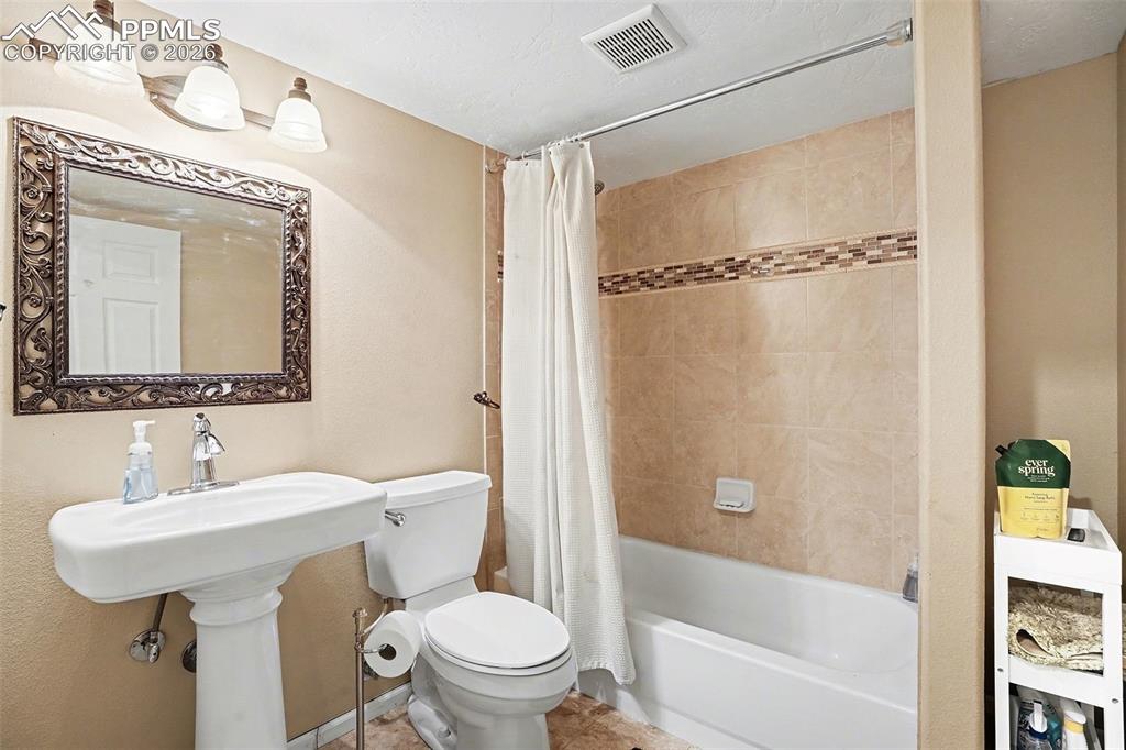 8265 Tannenbaum Road Colorado Springs, CO 80908 - Photo 14 of 50 a bathroom with a sink toilet and shower