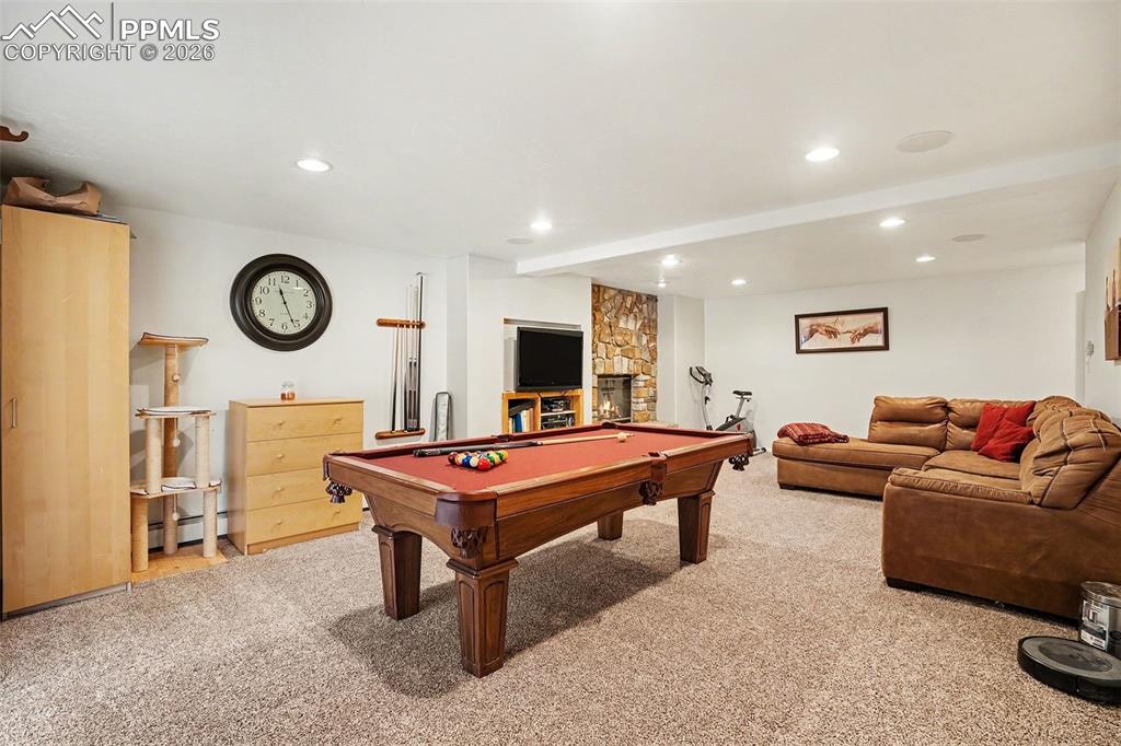 8265 Tannenbaum Road Colorado Springs, CO 80908 - Photo 16 of 50 a living room with furniture a rug and a flat screen tv