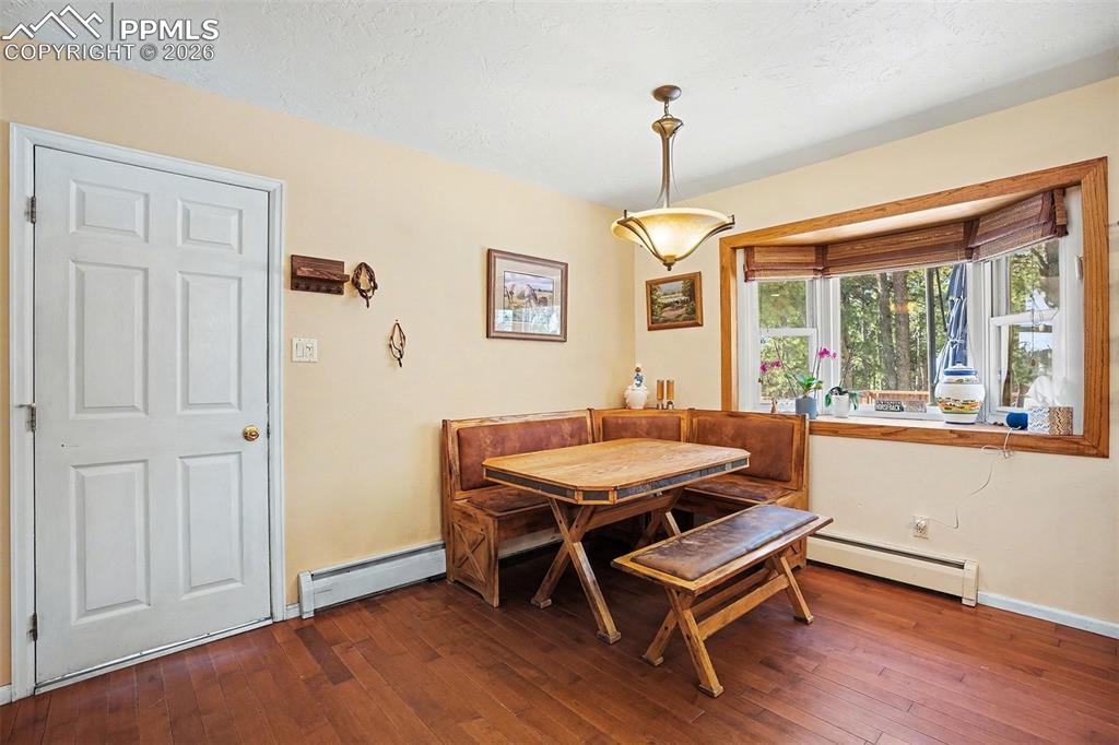 8265 Tannenbaum Road Colorado Springs, CO 80908 - Photo 17 of 50 a room with wooden floor pool table and windows