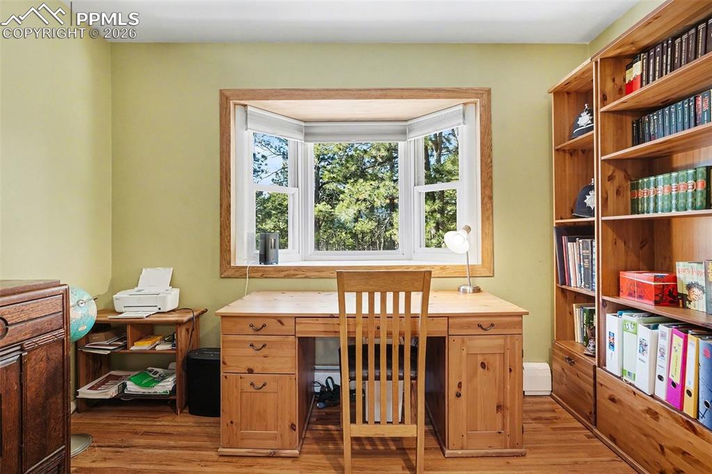 8265 Tannenbaum Road Colorado Springs, CO 80908 - Photo 20 of 50 a room with a bookshelf and a window