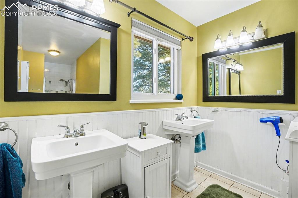 8265 Tannenbaum Road Colorado Springs, CO 80908 - Photo 21 of 50 a bathroom with a sink and a mirror