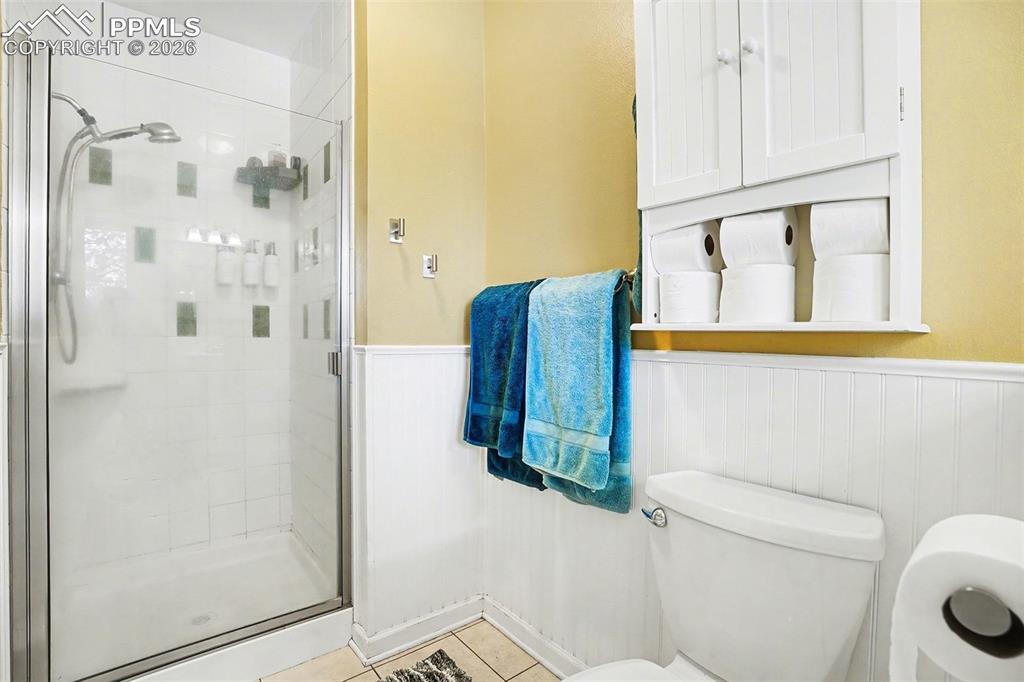 8265 Tannenbaum Road Colorado Springs, CO 80908 - Photo 22 of 50 a bathroom with a shower and toilet