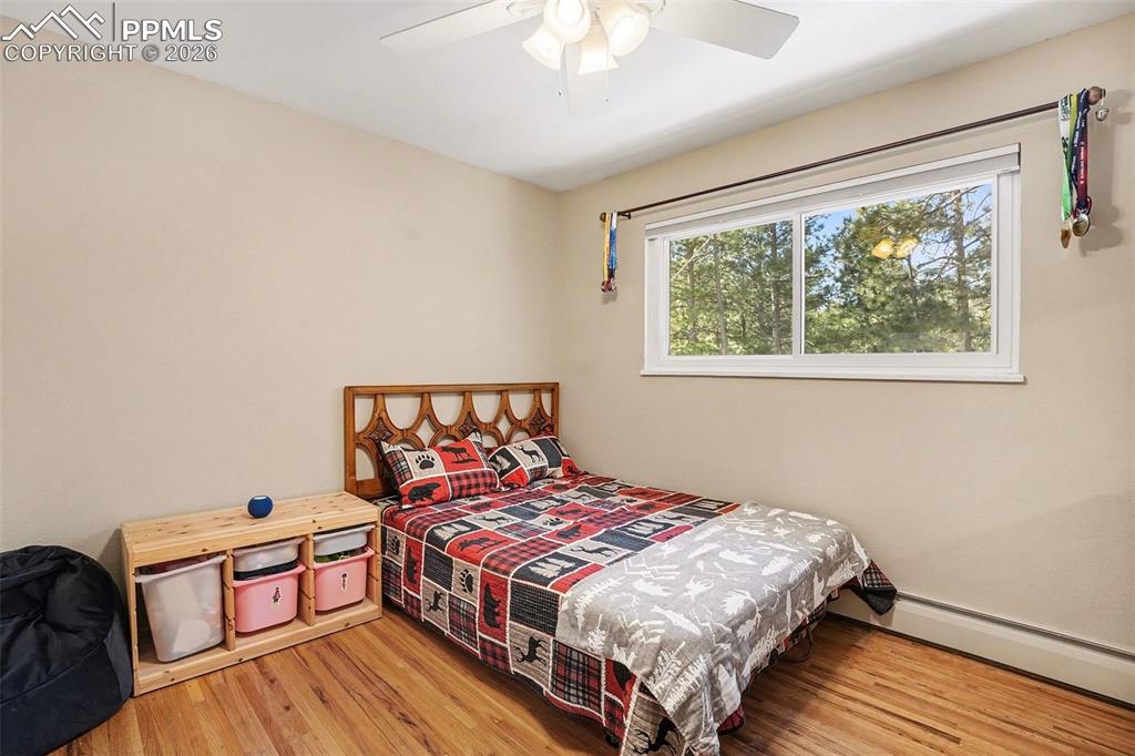 8265 Tannenbaum Road Colorado Springs, CO 80908 - Photo 23 of 50 a bedroom with a bed and a window