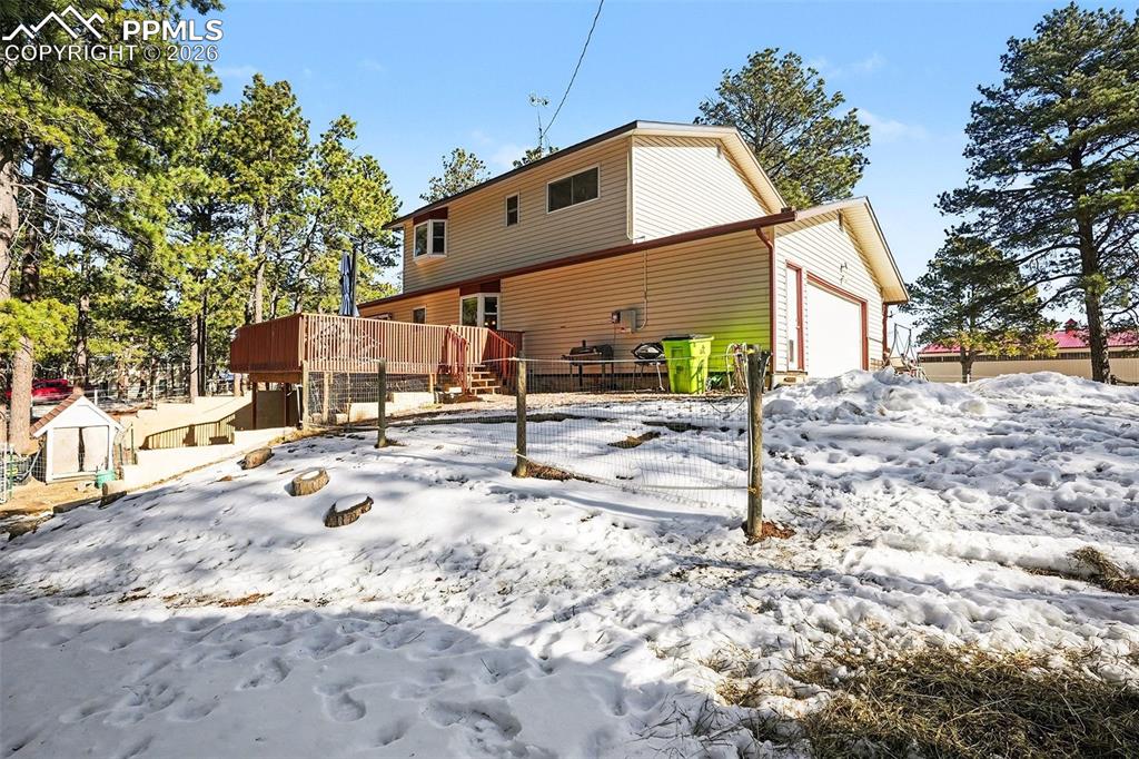 8265 Tannenbaum Road Colorado Springs, CO 80908 - Photo 27 of 50 a view of a blue house with snow on the background