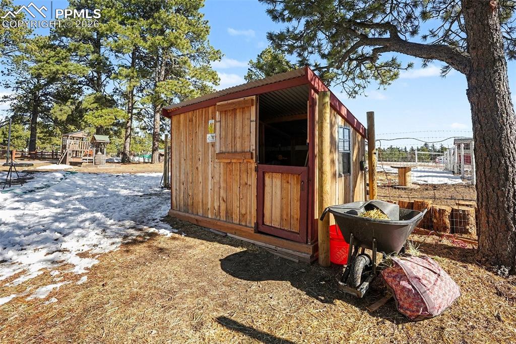 8265 Tannenbaum Road Colorado Springs, CO 80908 - Photo 40 of 50 a view of a room with a backyard and a tree