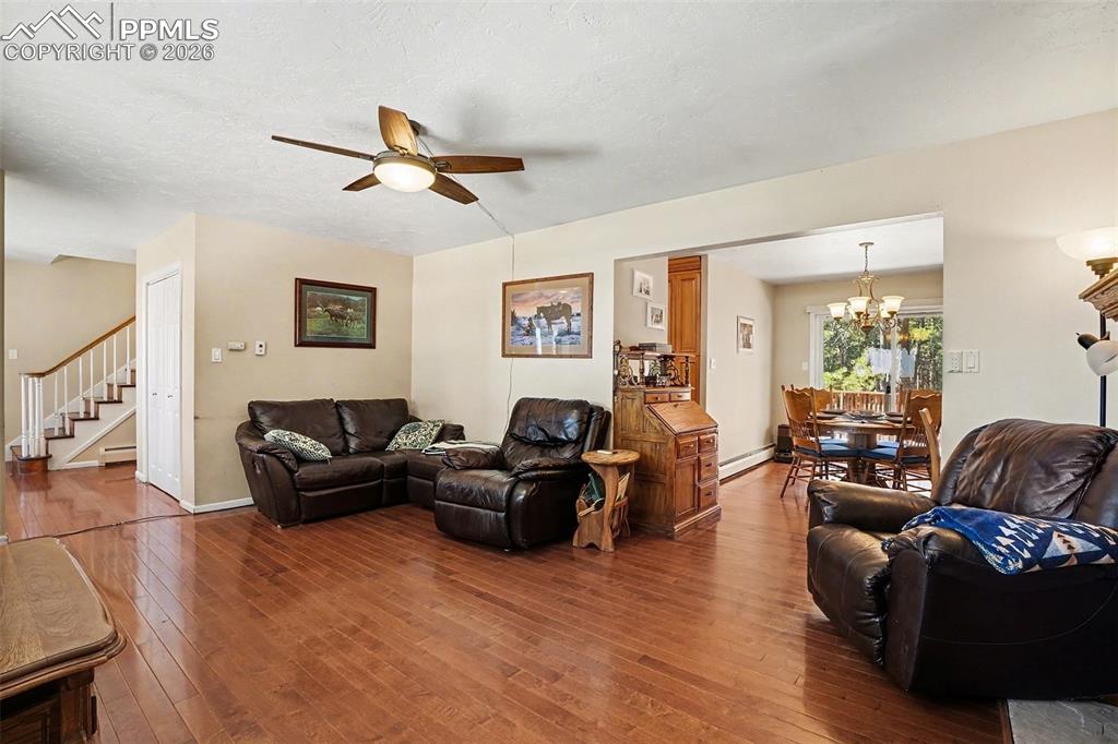 8265 Tannenbaum Road Colorado Springs, CO 80908 - Photo 5 of 50 a living room with furniture and a view of kitchen