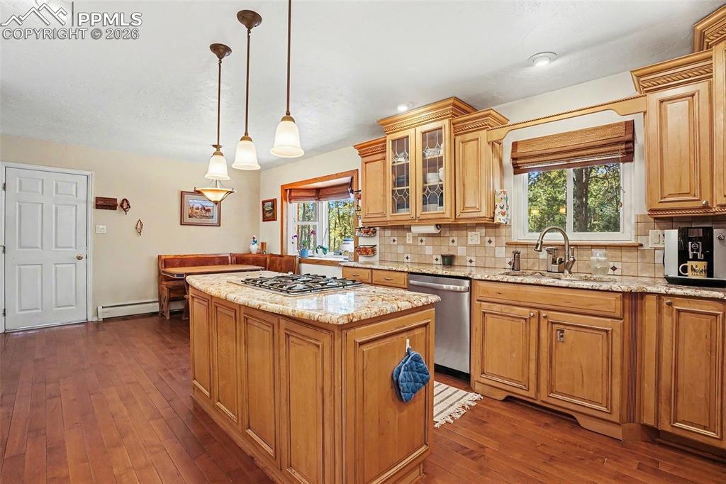 8265 Tannenbaum Road Colorado Springs, CO 80908 - Photo 10 of 50 a kitchen with stainless steel appliances granite countertop a stove and a sink