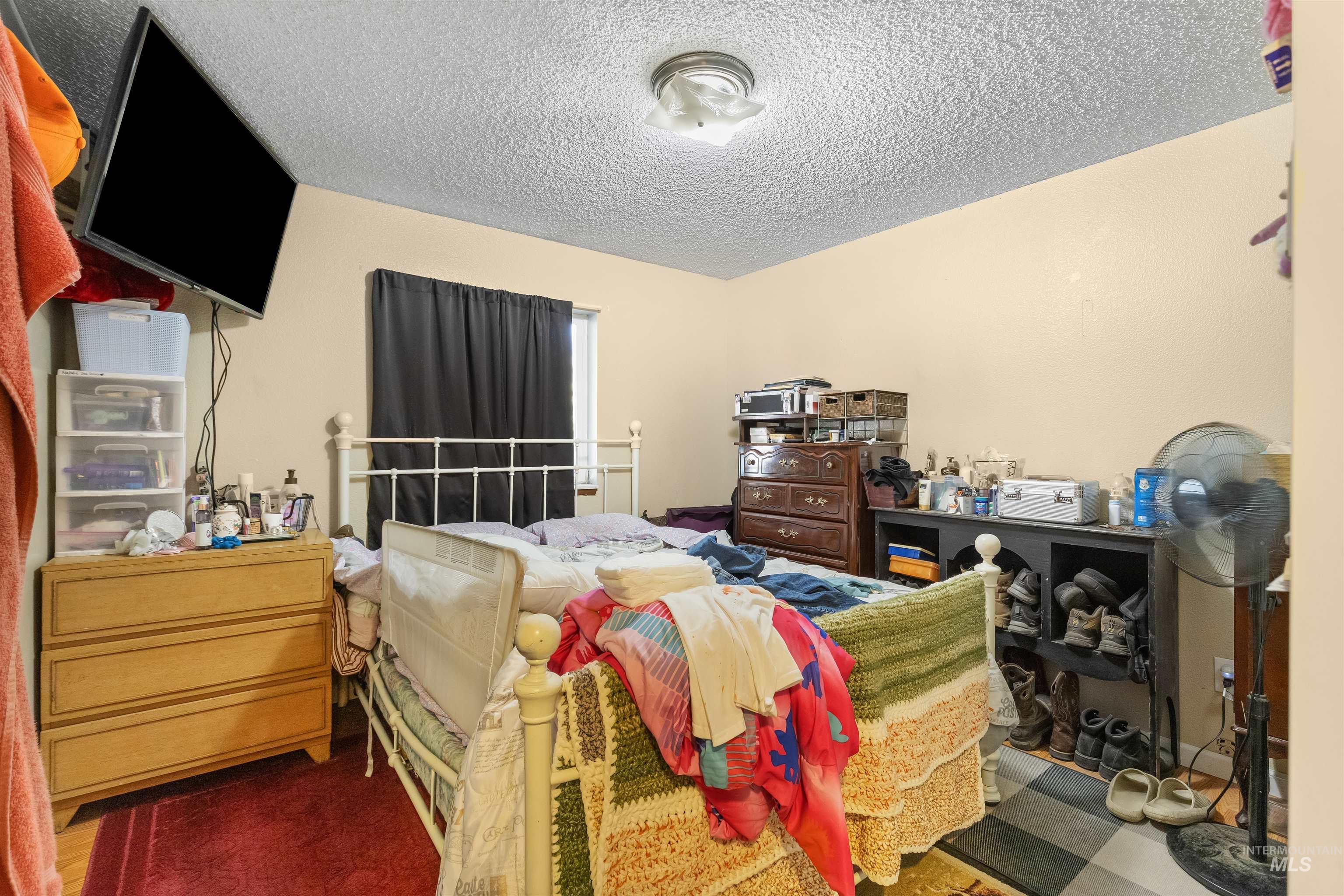 2460 State Street Pomeroy, WA 99347 - Photo 8 of 18 Cream-painted walls with textured ceiling and a ceiling-mounted light fixture