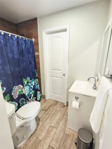 a bathroom with a sink toilet and mirror