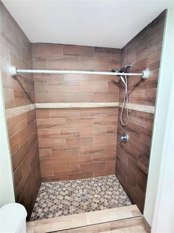 a bathroom with a glass door shower