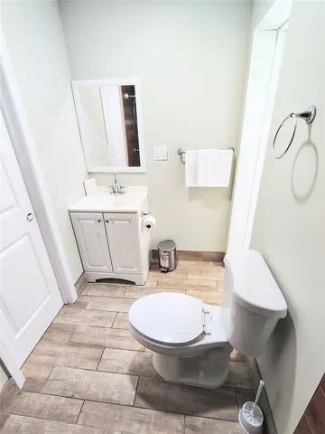 a bathroom with a sink a toilet and mirror