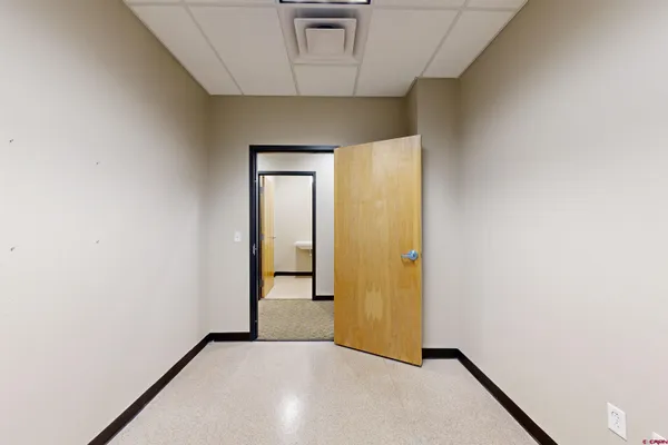a white toilet sitting next to a white sink