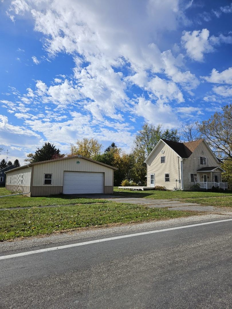 208 East Washington Street Dana, IL 61321 - Photo 1 of 28 a view of a house with a big yard and large trees