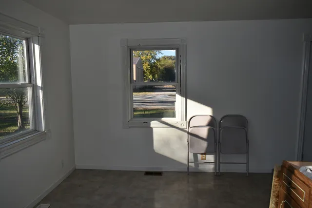 a room with a chair and a window