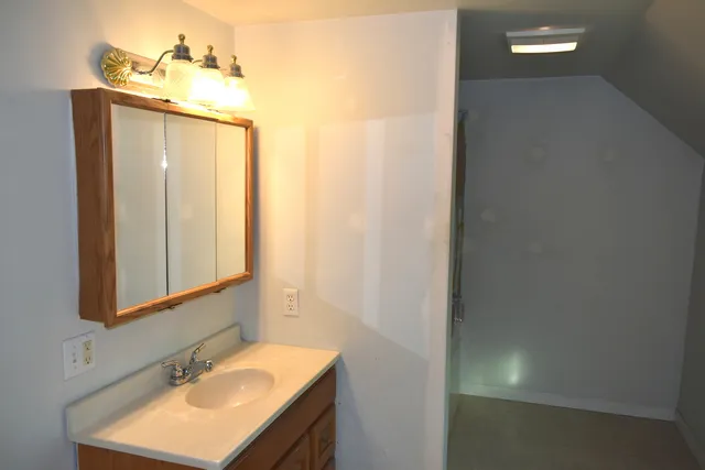 a bathroom with a sink and a mirror