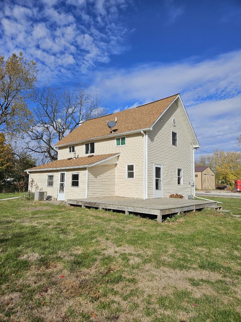 208 East Washington Street Dana, IL 61321 - Photo 4 of 28 a front view of a house with a garden