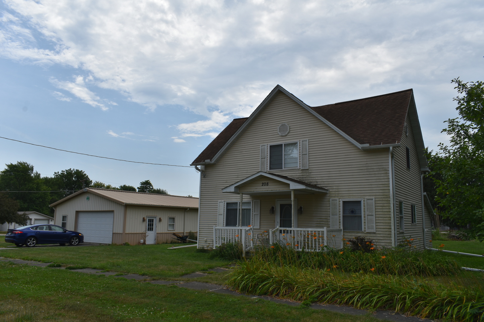 208 East Washington Street Dana, IL 61321 - Photo 5 of 28 a front view of a house with a garden