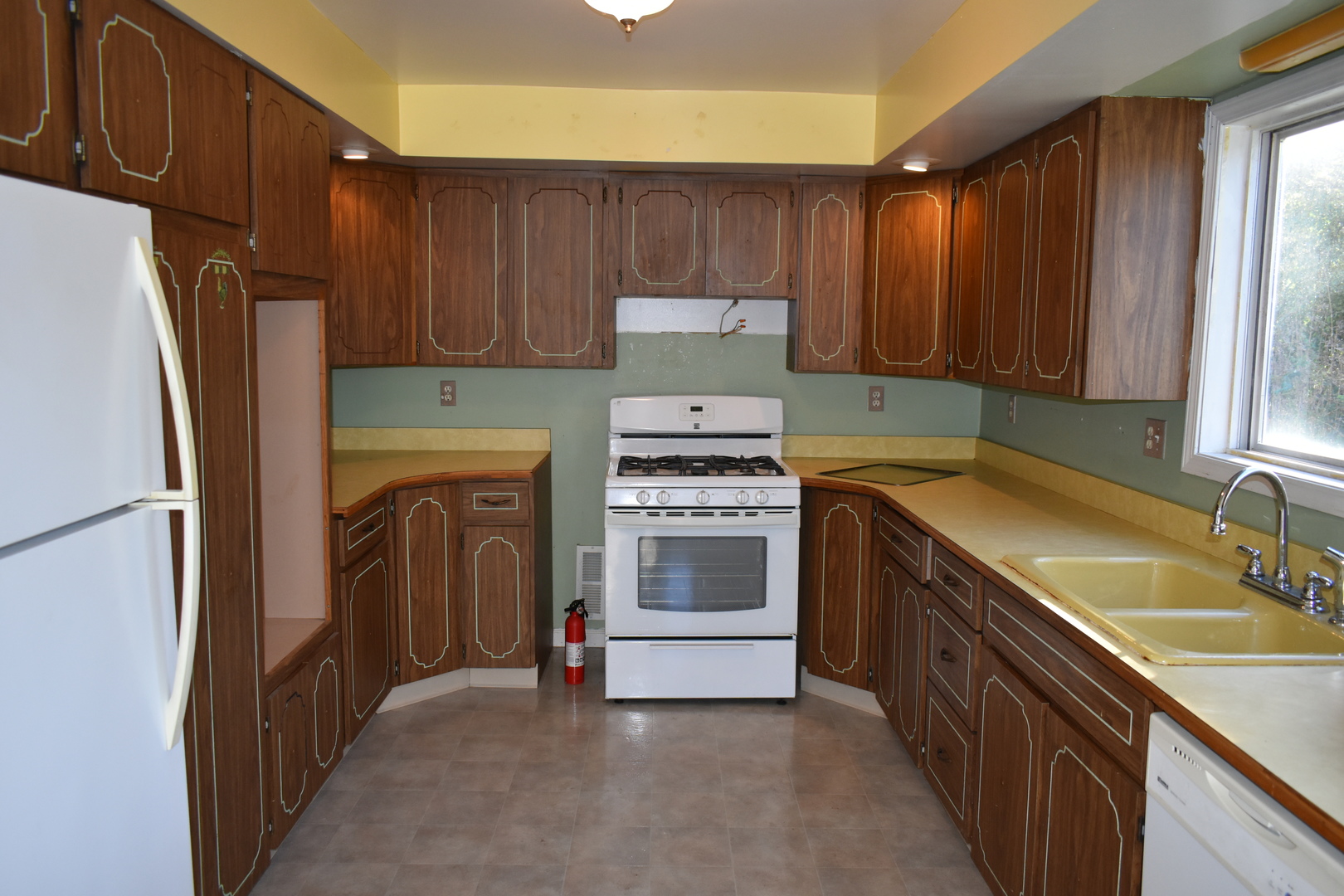 208 East Washington Street Dana, IL 61321 - Photo 7 of 28 a kitchen with a refrigerator sink and cabinets
