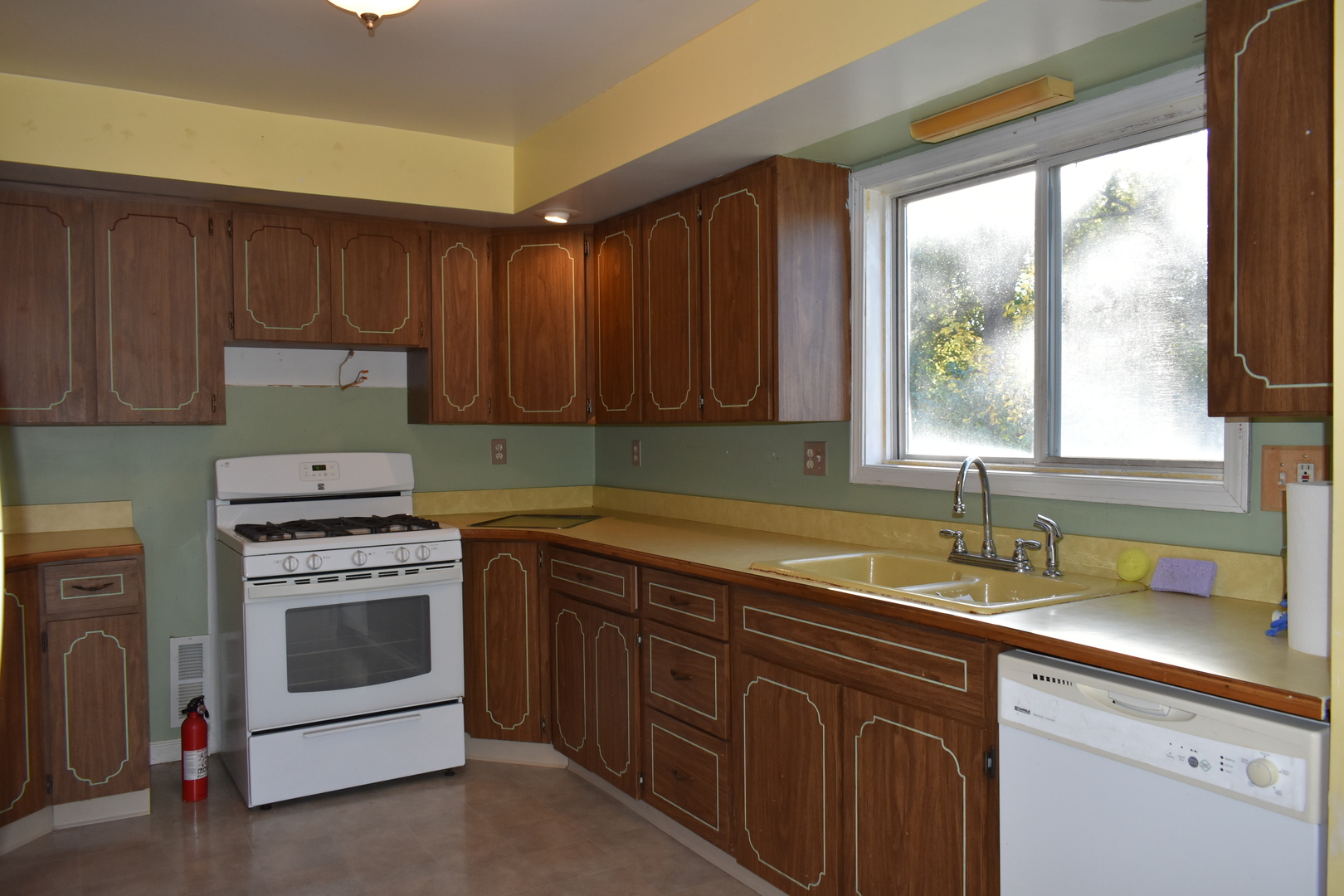 208 East Washington Street Dana, IL 61321 - Photo 9 of 28 a kitchen with a sink stove and cabinets