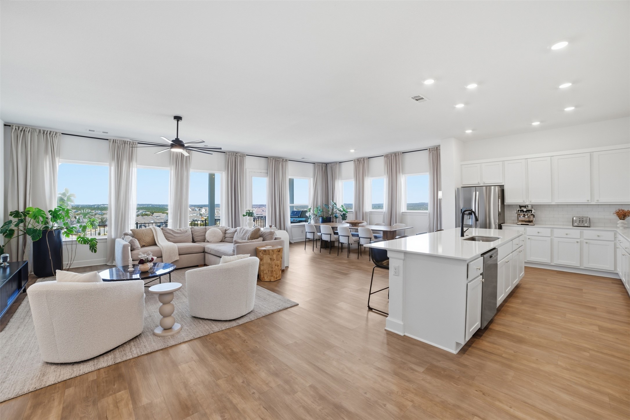 256 Smoke Tree Circle Dripping Springs, TX 78620 - Photo 10 of 40 a living room with furniture a large window and wooden floors
