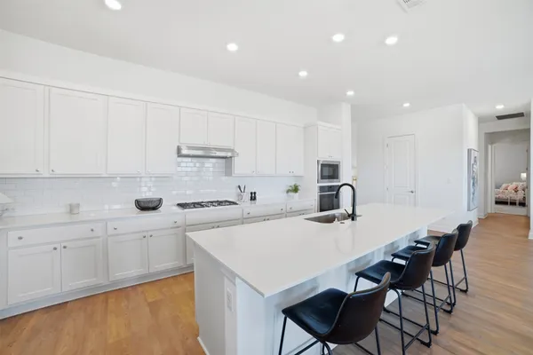 a kitchen with a sink and a large window