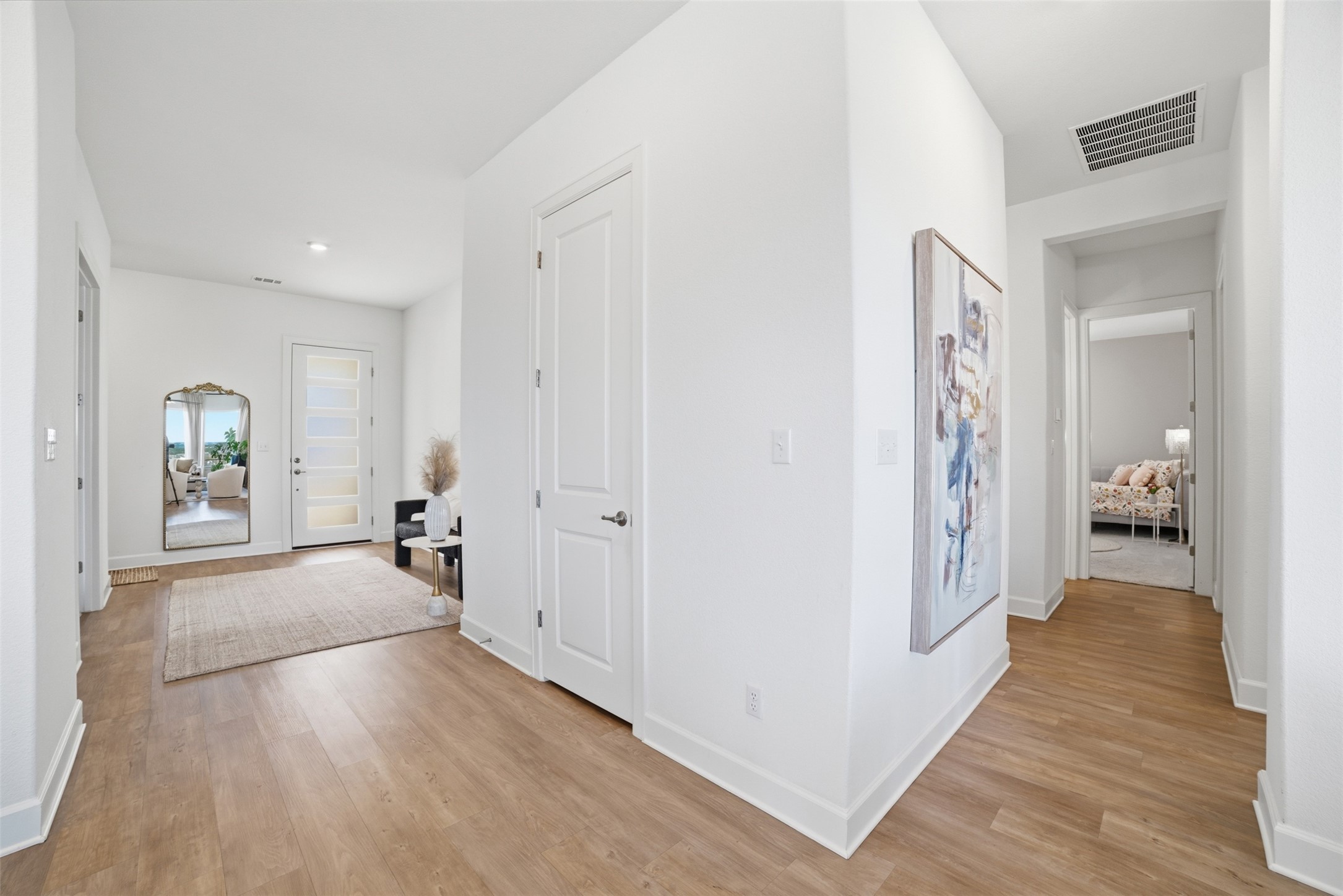 256 Smoke Tree Circle Dripping Springs, TX 78620 - Photo 17 of 40 a view of a hallway with wooden floor and furniture