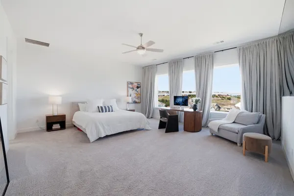 a view of a hallway with wooden floor and furniture