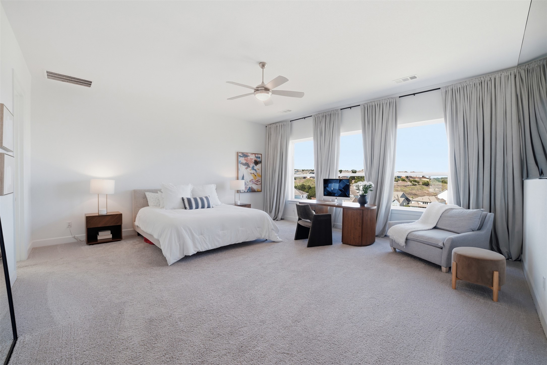 256 Smoke Tree Circle Dripping Springs, TX 78620 - Photo 19 of 40 a bedroom with furniture and a large window