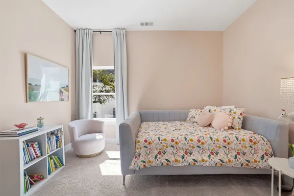 a bathroom with double vanity sinks a large mirror and a bathtub