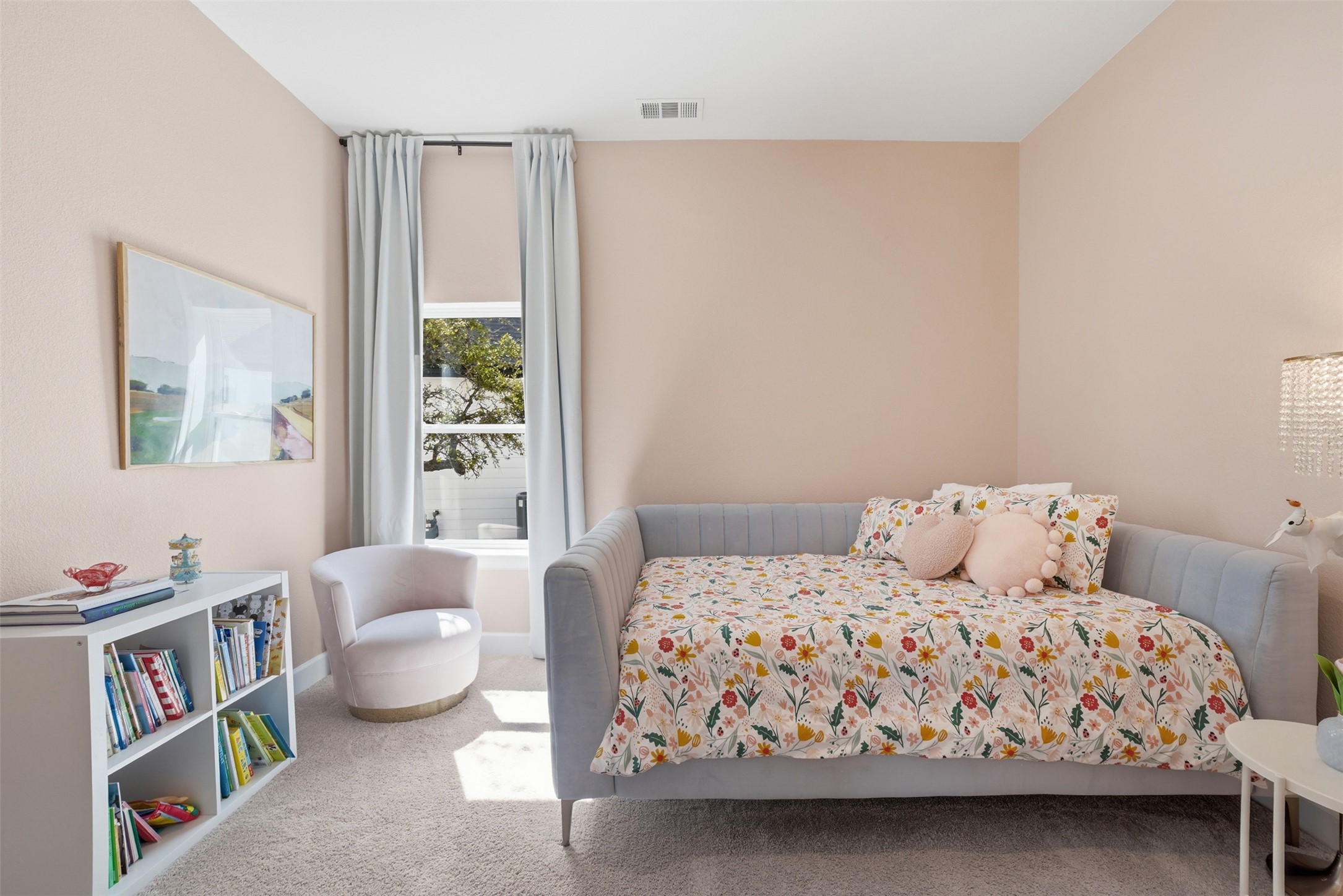 256 Smoke Tree Circle Dripping Springs, TX 78620 - Photo 24 of 40 a bedroom with a bed wooden floor and a large window