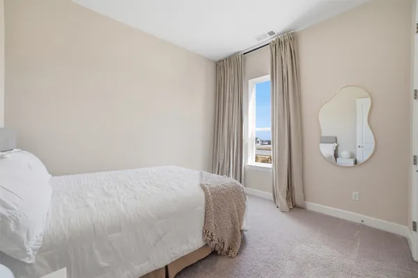 a bedroom with furniture and a chandelier