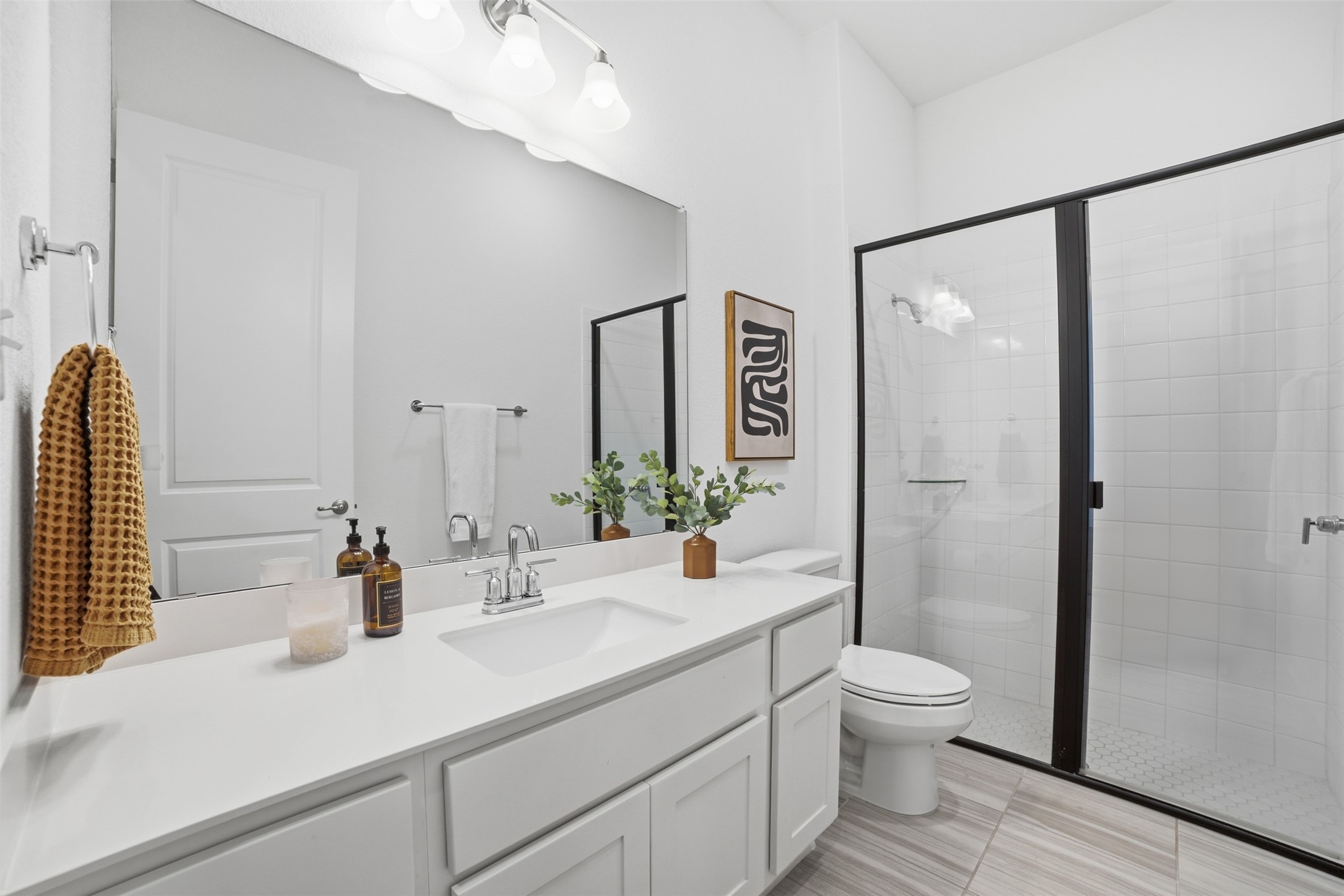256 Smoke Tree Circle Dripping Springs, TX 78620 - Photo 29 of 40 a bathroom with a sink a toilet and shower