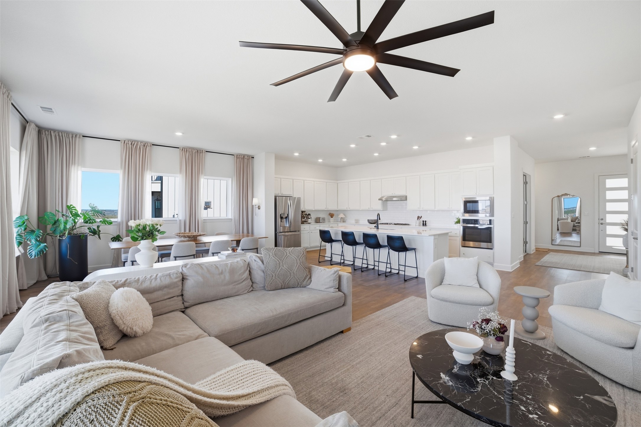 256 Smoke Tree Circle Dripping Springs, TX 78620 - Photo 5 of 40 a living room with furniture kitchen view and a chandelier