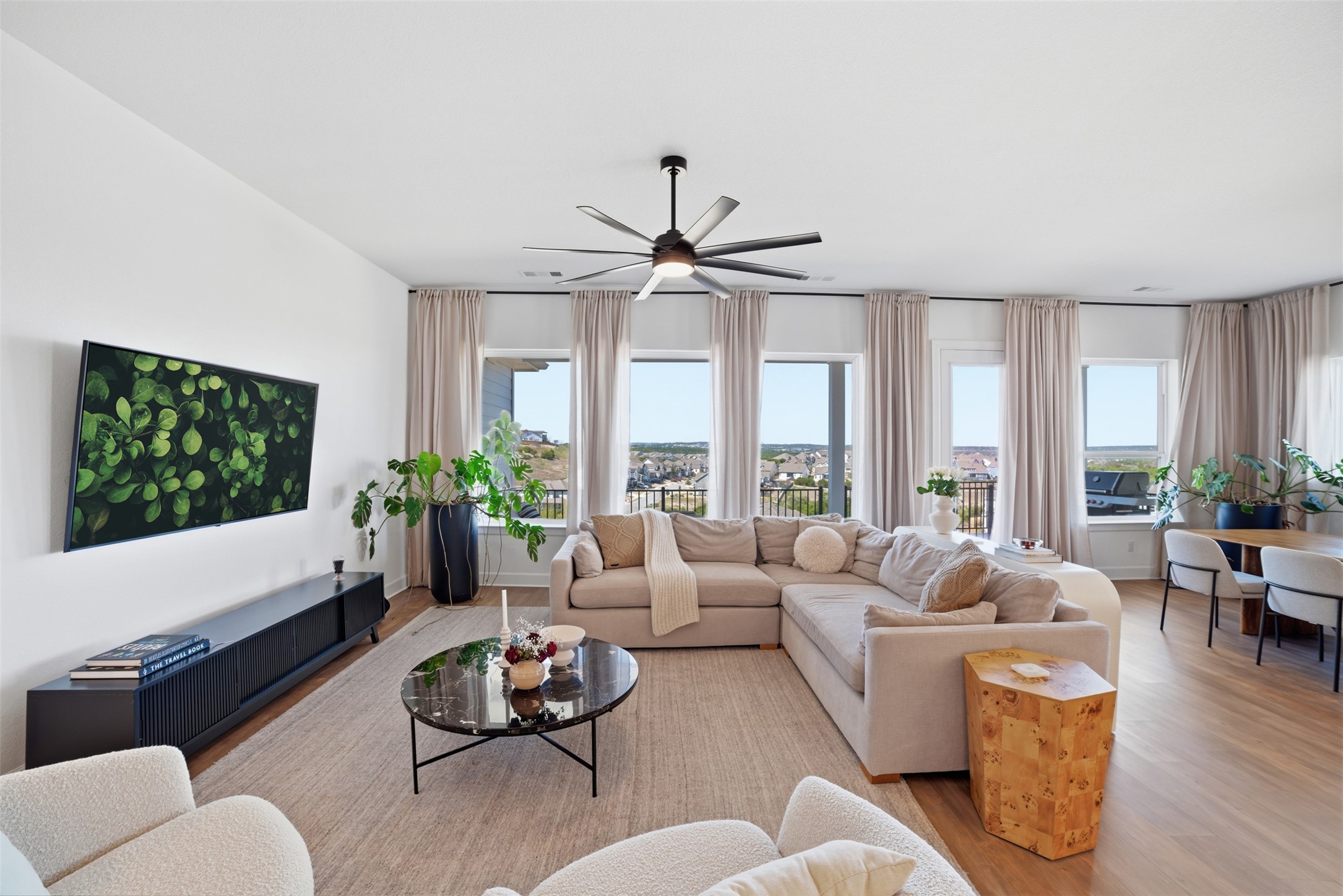 256 Smoke Tree Circle Dripping Springs, TX 78620 - Photo 8 of 40 a living room with furniture ceiling fan and a large window