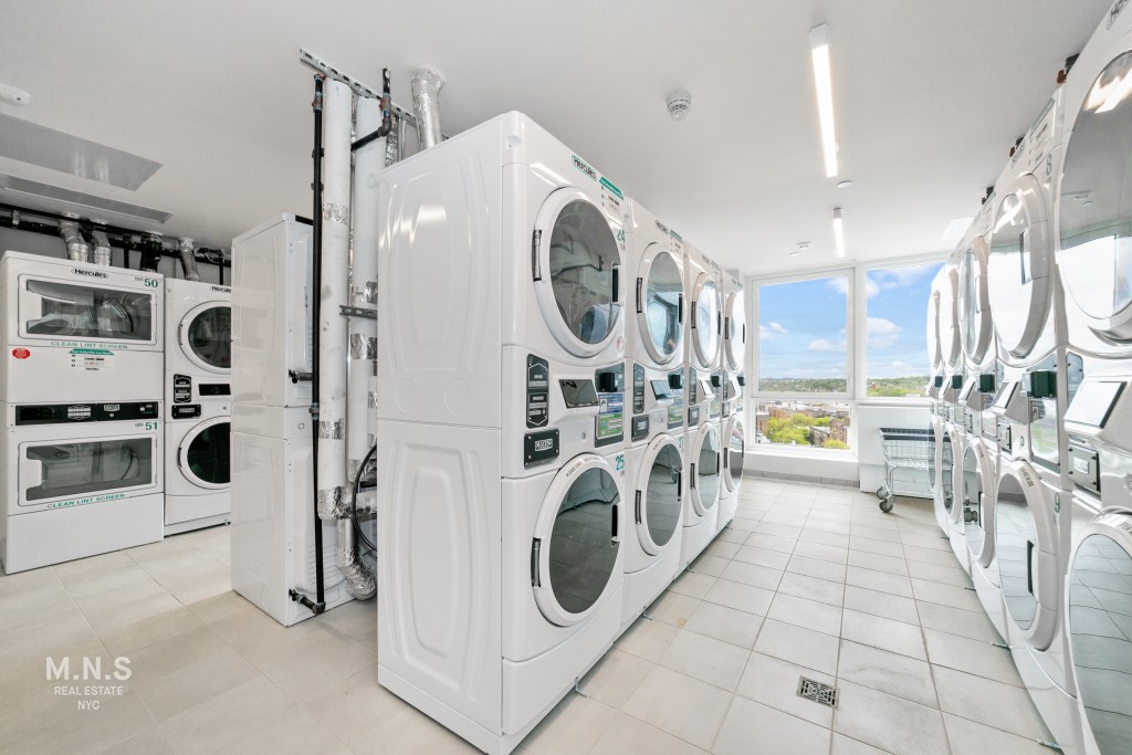 a utility room with multiple dryer and washer