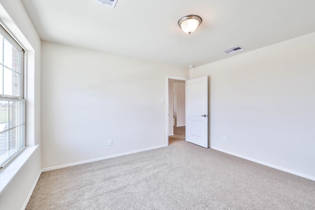 247 Sintra Lk Way Rosenberg, TX 77469 - Photo 27 of 28 an empty room with a empty space and windows