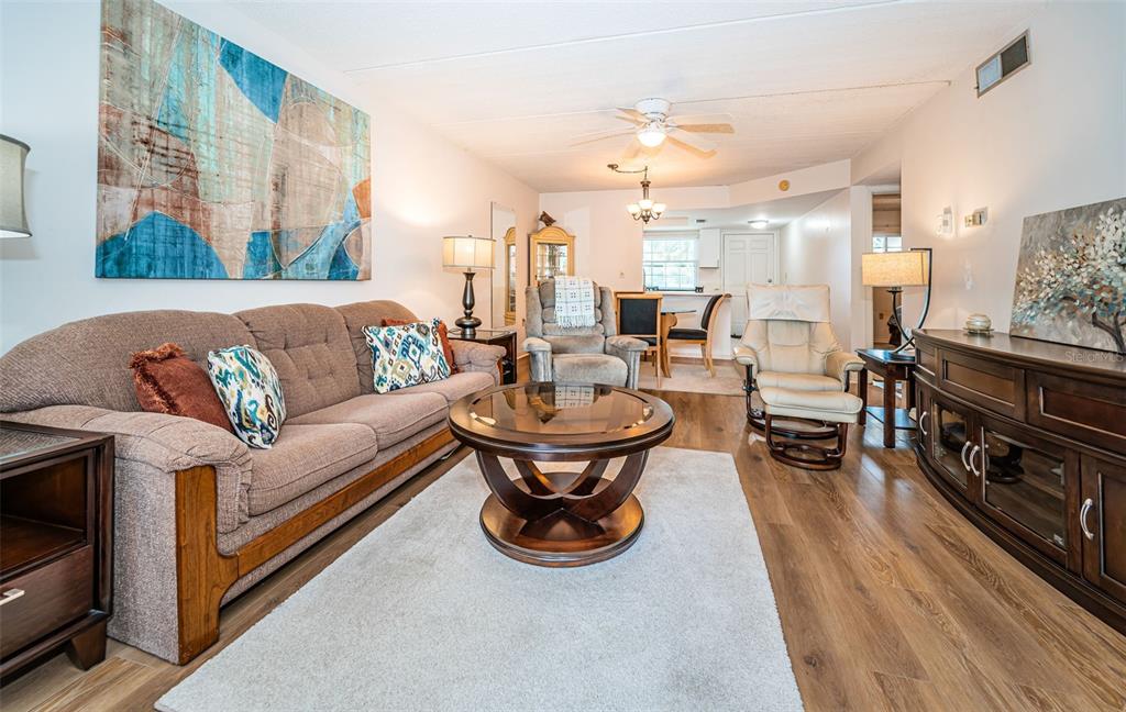 920 Virginia Street, Unit 302 Dunedin, FL 34698 - Photo 17 of 66 a living room with furniture and a fireplace