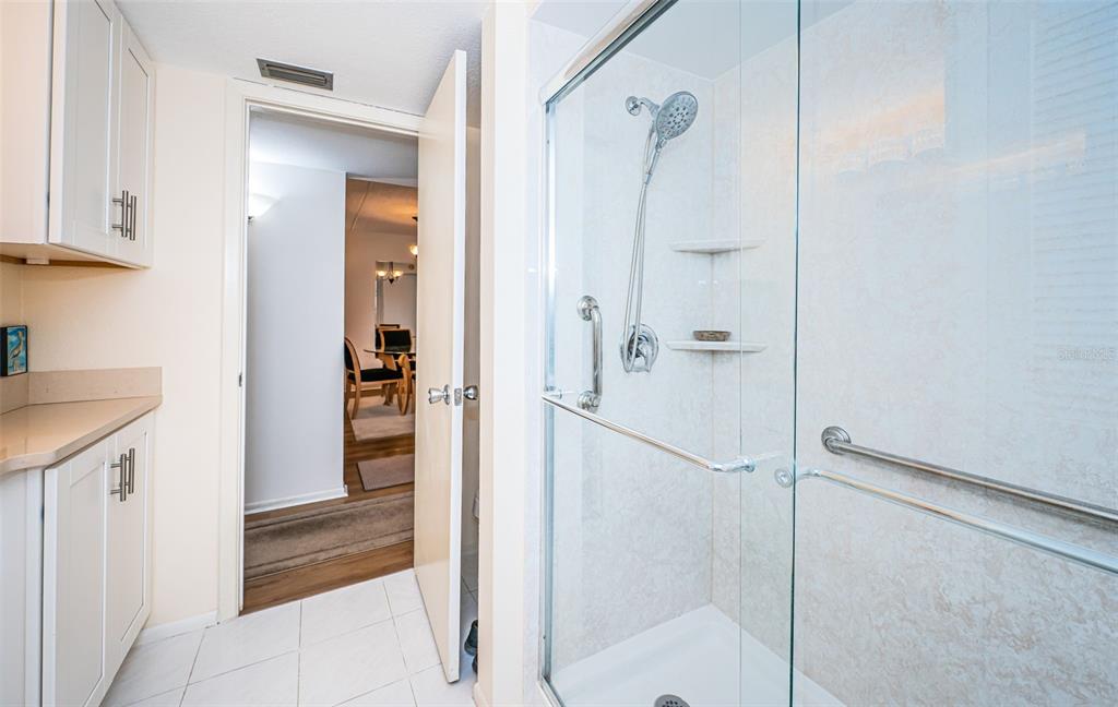 920 Virginia Street, Unit 302 Dunedin, FL 34698 - Photo 33 of 66 a bathroom with a granite countertop shower mirror and a sink