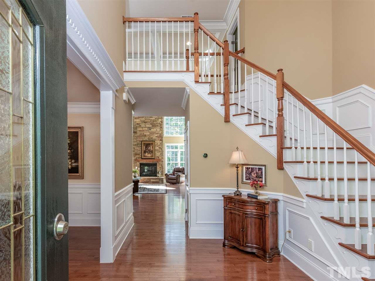 4717 Haleytree Court Raleigh, NC 27606 - Photo 3 of 30 Enter into a 2 story elegant foyer with curved staircase, heavy trim throughout the home, upgraded hardwoods!