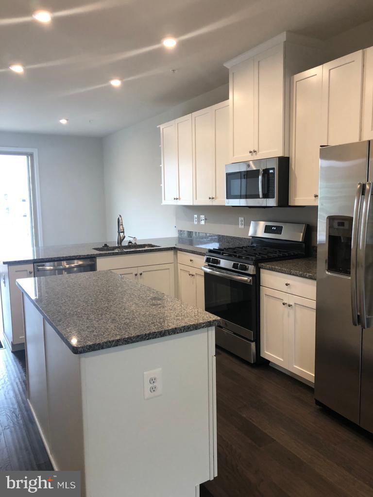 3102 Potters Hill Road Hanover, MD 21076 - Photo 12 of 28 a kitchen with stainless steel appliances granite countertop a sink dishwasher stove top oven and refrigerator