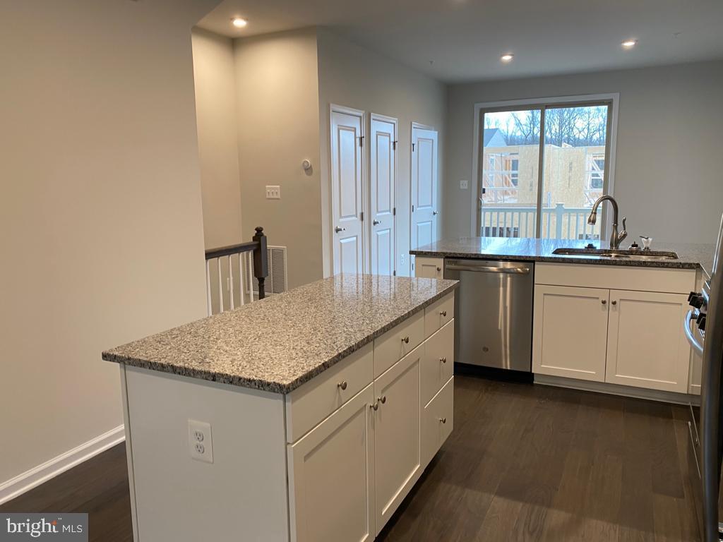 3102 Potters Hill Road Hanover, MD 21076 - Photo 14 of 28 a kitchen with stainless steel appliances granite countertop a sink a stove and a microwave