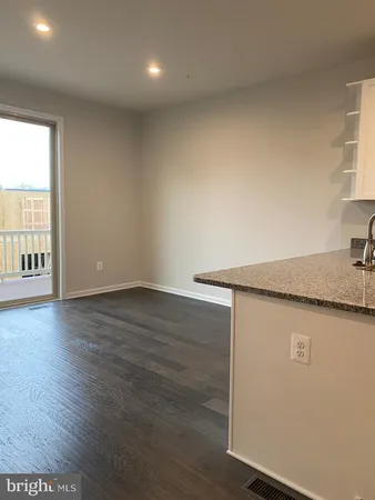 an empty room with wooden floor