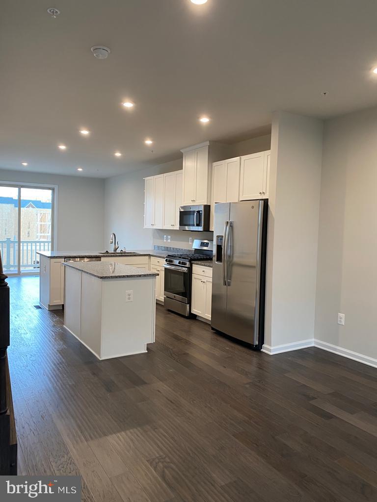 3102 Potters Hill Road Hanover, MD 21076 - Photo 20 of 28 a kitchen with stainless steel appliances granite countertop a refrigerator a stove a sink and a microwave