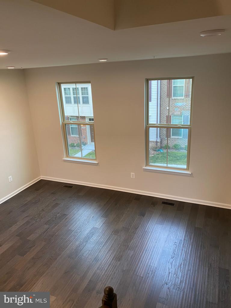 3102 Potters Hill Road Hanover, MD 21076 - Photo 22 of 28 a view of an empty room with wooden floor and a window