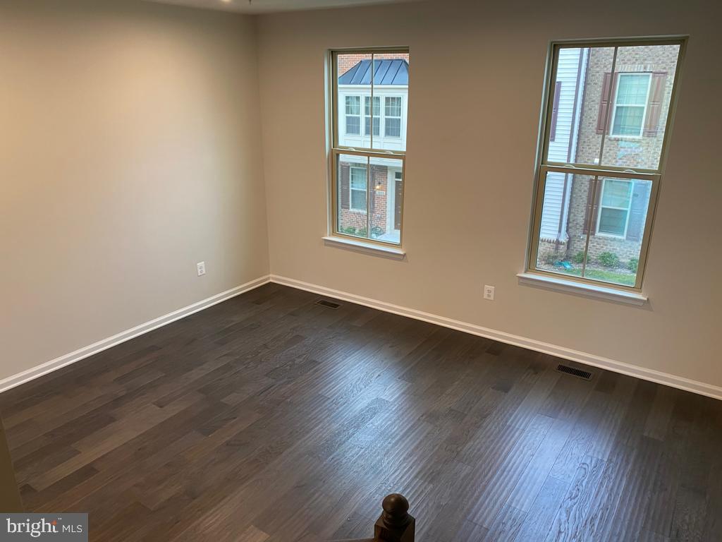 3102 Potters Hill Road Hanover, MD 21076 - Photo 26 of 28 a view of an empty room with wooden floor and a window