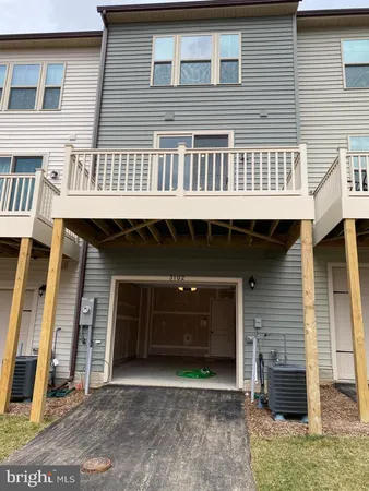 a front view of a house with many windows