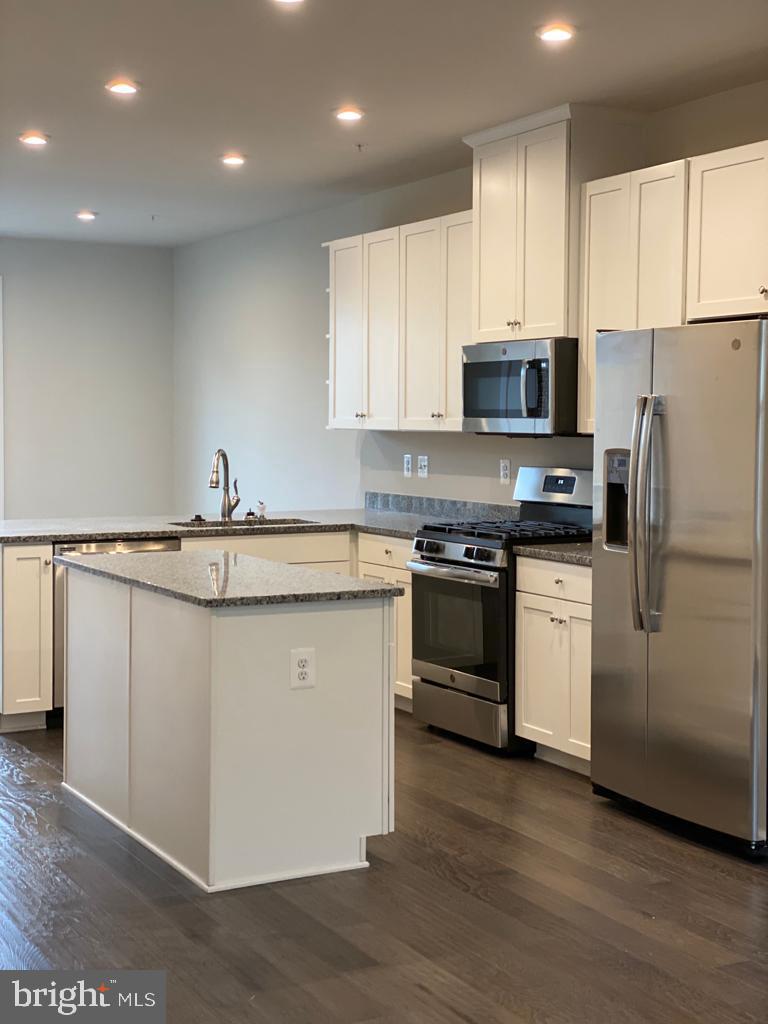 3102 Potters Hill Road Hanover, MD 21076 - Photo 5 of 28 a kitchen with stainless steel appliances granite countertop a stove a sink and a refrigerator