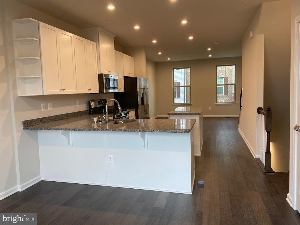 3102 Potters Hill Road Hanover, MD 21076 - Photo 6 of 28 a kitchen with stainless steel appliances granite countertop a sink stove and cabinets